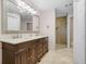 A spacious primary bath features a double sink vanity and walk-in shower at 16538 Rockwell Heights Ln, Clermont, FL 34711
