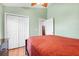 A nice bedroom with a ceiling fan and access to the closet at 16538 Rockwell Heights Ln, Clermont, FL 34711