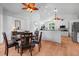 An open dining room features hardwood floors and modern ceiling fans at 16538 Rockwell Heights Ln, Clermont, FL 34711