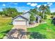 Well-maintained home with spacious lawn, brick driveway, two-car garage, and front yard landscaping at 16538 Rockwell Heights Ln, Clermont, FL 34711