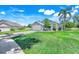 Well-maintained home with a spacious lawn, paved driveway, and inviting front entrance at 16538 Rockwell Heights Ln, Clermont, FL 34711