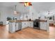Kitchen with stainless steel appliances and modern cabinetry, with an open layout and hardwood floors at 16538 Rockwell Heights Ln, Clermont, FL 34711