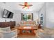 Bright living room with hardwood floors, comfortable seating, and a view to the outside at 16538 Rockwell Heights Ln, Clermont, FL 34711