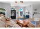 Open-concept living room with natural light, wood floors, and comfortable furnishings at 16538 Rockwell Heights Ln, Clermont, FL 34711