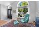 Bright living room with comfortable chairs, a large window, and stylish decor at 16538 Rockwell Heights Ln, Clermont, FL 34711