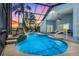 Enjoy the screened-in pool with waterfall feature, beautiful patio, and exterior access through sliding glass doors at 16538 Rockwell Heights Ln, Clermont, FL 34711
