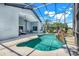 This tranquil screened pool area features a rock waterfall and ample patio space at 16538 Rockwell Heights Ln, Clermont, FL 34711