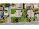 An aerial view showcases a well-maintained home with a manicured lawn and driveway at 1743 Landrum Ln, The Villages, FL 32162