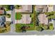 An aerial view showcases a well-maintained home with a manicured lawn and driveway at 1743 Landrum Ln, The Villages, FL 32162