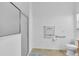Well-lit bathroom featuring a glass shower, accessible grab bars, and modern fixtures at 1743 Landrum Ln, The Villages, FL 32162