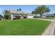 Inviting home with a green lawn, neat landscaping, and a paved driveway for easy access at 1743 Landrum Ln, The Villages, FL 32162