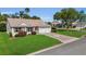 Charming home with beautiful lawn, landscaping and a decorative driveway at 1743 Landrum Ln, The Villages, FL 32162