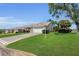 Charming home with lush front lawn and well-manicured landscaping and a two car garage at 1743 Landrum Ln, The Villages, FL 32162