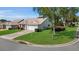 Well-manicured front yard with lush green grass and mature landscaping at 1743 Landrum Ln, The Villages, FL 32162