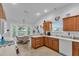 An eat-in kitchen with bright lighting and wooden cabinetry at 1743 Landrum Ln, The Villages, FL 32162