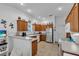 Well-lit kitchen with stainless steel appliances and decorative items atop wood cabinetry at 1743 Landrum Ln, The Villages, FL 32162