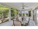 Enclosed lanai with ceiling fan, comfortable seating, and beautiful views of the surrounding greenery at 1743 Landrum Ln, The Villages, FL 32162