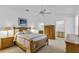 A main bedroom with a ceiling fan and ensuite bathroom and walk-in closet at 1743 Landrum Ln, The Villages, FL 32162