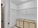 Bright walk-in closet with wire shelving and built-in dresser storage for organized and efficient storage at 1743 Landrum Ln, The Villages, FL 32162