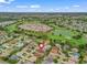 Aerial view showcasing location, golf course community, and beautiful lake at 17930 Se 87Th Bourne Ave, The Villages, FL 32162