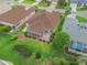 Aerial view of the home showcasing the well-maintained backyard, screened lanai, and mature landscaping at 17930 Se 87Th Bourne Ave, The Villages, FL 32162