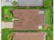 Drone shot of home from above highlighting roof, driveway compass, professional landscaping, and lawn at 17930 Se 87Th Bourne Ave, The Villages, FL 32162