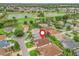 An aerial view showcases the home's location near a golf course, lakes, and beautiful landscaping at 17930 Se 87Th Bourne Ave, The Villages, FL 32162