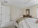 Cozy bedroom featuring a bed, dresser, and closet with carpet flooring at 17930 Se 87Th Bourne Ave, The Villages, FL 32162