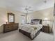 Well-decorated bedroom with a comfortable bed, side tables, and wicker decor at 17930 Se 87Th Bourne Ave, The Villages, FL 32162