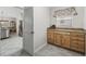 Butler's pantry features wooden cabinets, counter, and view into kitchen at 17930 Se 87Th Bourne Ave, The Villages, FL 32162