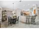 Bright dining area showcasing tile flooring, adjacent kitchen, and open floor plan at 17930 Se 87Th Bourne Ave, The Villages, FL 32162