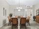 Formal dining room featuring elegant lighting and decor, perfect for intimate gatherings and entertaining guests at 17930 Se 87Th Bourne Ave, The Villages, FL 32162