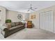 Cozy living area with a comfortable sofa, armchair, and neutral decor at 17930 Se 87Th Bourne Ave, The Villages, FL 32162