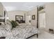 Spacious main bedroom with a four-poster bed, and ensuite bathroom access at 17930 Se 87Th Bourne Ave, The Villages, FL 32162