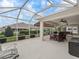 Enclosed patio features a dining area with outdoor seating and a lounge area at 17930 Se 87Th Bourne Ave, The Villages, FL 32162