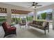 Comfortable screened patio featuring a seating area with a sofa and chairs at 17930 Se 87Th Bourne Ave, The Villages, FL 32162