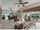 Screened patio with multiple ceiling fans and patio furniture at 17930 Se 87Th Bourne Ave, The Villages, FL 32162
