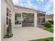 Covered and screened patio area with ceiling fans and comfortable outdoor furniture, perfect for relaxing and entertaining at 17930 Se 87Th Bourne Ave, The Villages, FL 32162