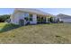 Expansive backyard with a covered patio and ample space for outdoor activities at 1922 Angel Fish Loop, Leesburg, FL 34748