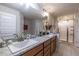 Bathroom with double sinks, granite countertops, and modern fixtures at 1922 Angel Fish Loop, Leesburg, FL 34748