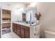 Large bathroom featuring double sinks, granite countertops, and a bathtub at 1922 Angel Fish Loop, Leesburg, FL 34748