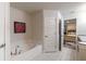 Bright bathroom featuring a soaking tub and access to the main bedroom at 1922 Angel Fish Loop, Leesburg, FL 34748