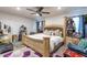 Comfortable bedroom with a cozy bed, ceiling fan, and natural light at 1922 Angel Fish Loop, Leesburg, FL 34748