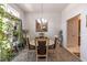 Dining room with carpet, plants, and a modern light fixture above a round table at 1922 Angel Fish Loop, Leesburg, FL 34748