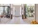 View of a well-decorated entryway with tiled floors, plants and a white front door at 1922 Angel Fish Loop, Leesburg, FL 34748