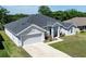 Well-maintained home showcasing a neat lawn and a driveway leading to a spacious two-car garage at 1922 Angel Fish Loop, Leesburg, FL 34748