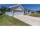The home's exterior displays a spacious driveway and an attached two-car garage at 1922 Angel Fish Loop, Leesburg, FL 34748