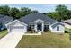 Charming single-story home featuring a well-manicured lawn and a classic two-car garage at 1922 Angel Fish Loop, Leesburg, FL 34748