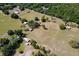 Expansive aerial view of a property with a large lot, scattered trees, and multiple structures at 19726 Mccall Rd, Altoona, FL 32702