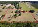 Sprawling acreage with property lines drawn over a vast lot, including trees, outbuildings, and open fields at 19726 Mccall Rd, Altoona, FL 32702